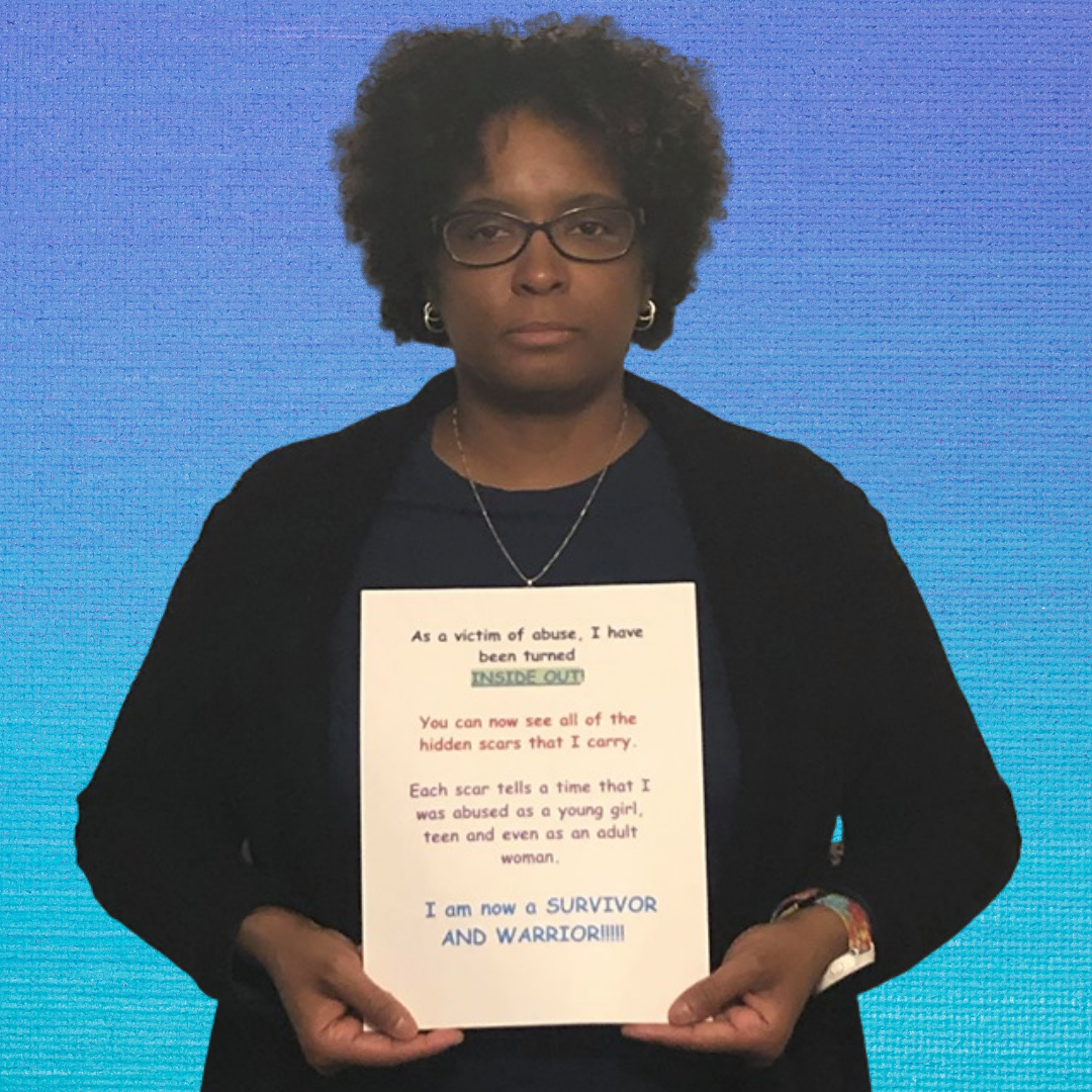 Anika holding a sign with her message