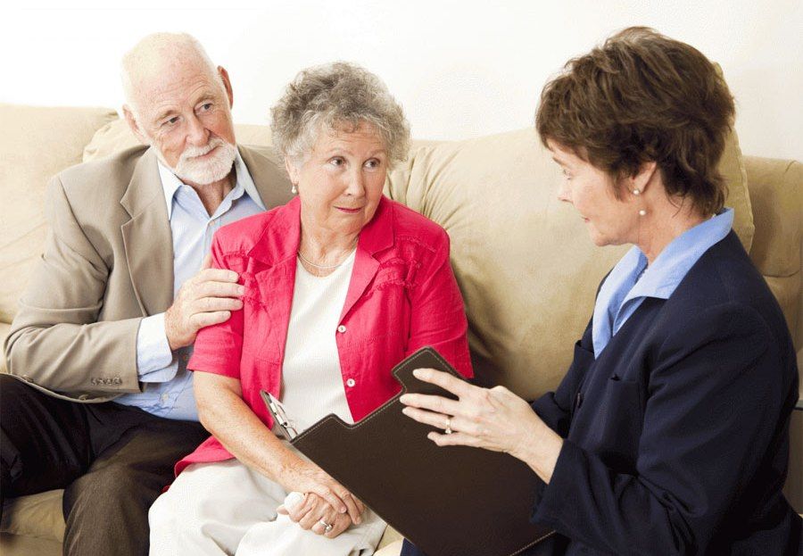 Elderly Couple talking to professional