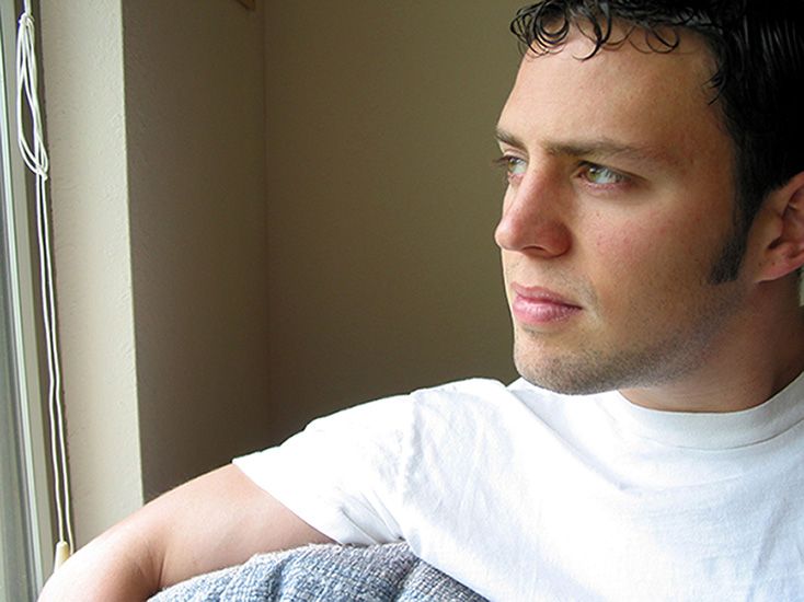 Young Man Looking Out Window